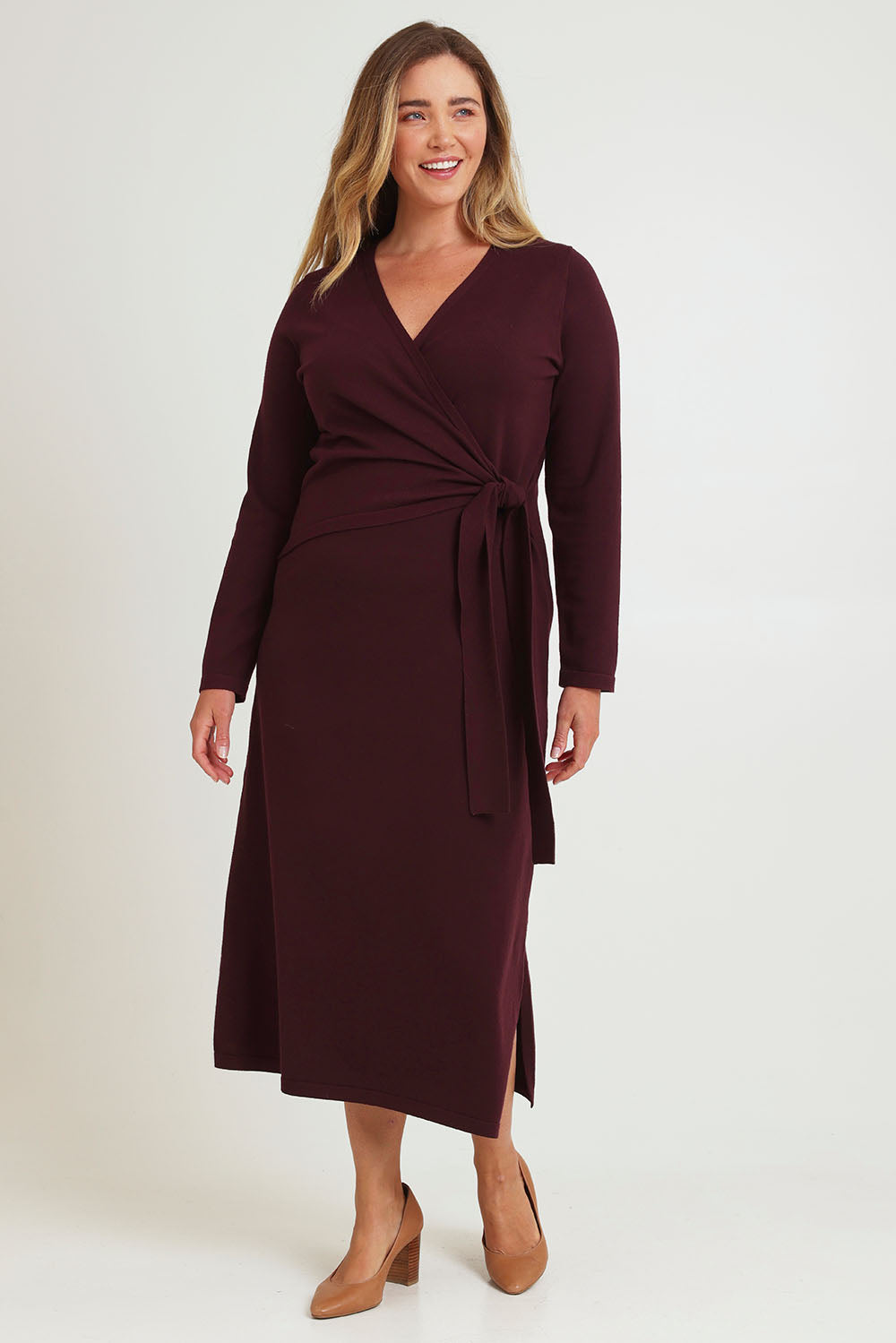Model Chanel wearing size XL of The Tie Waist Faux Wrap Knit Dress in colour Burntplum (Purple), from the front, showing the whole outfit