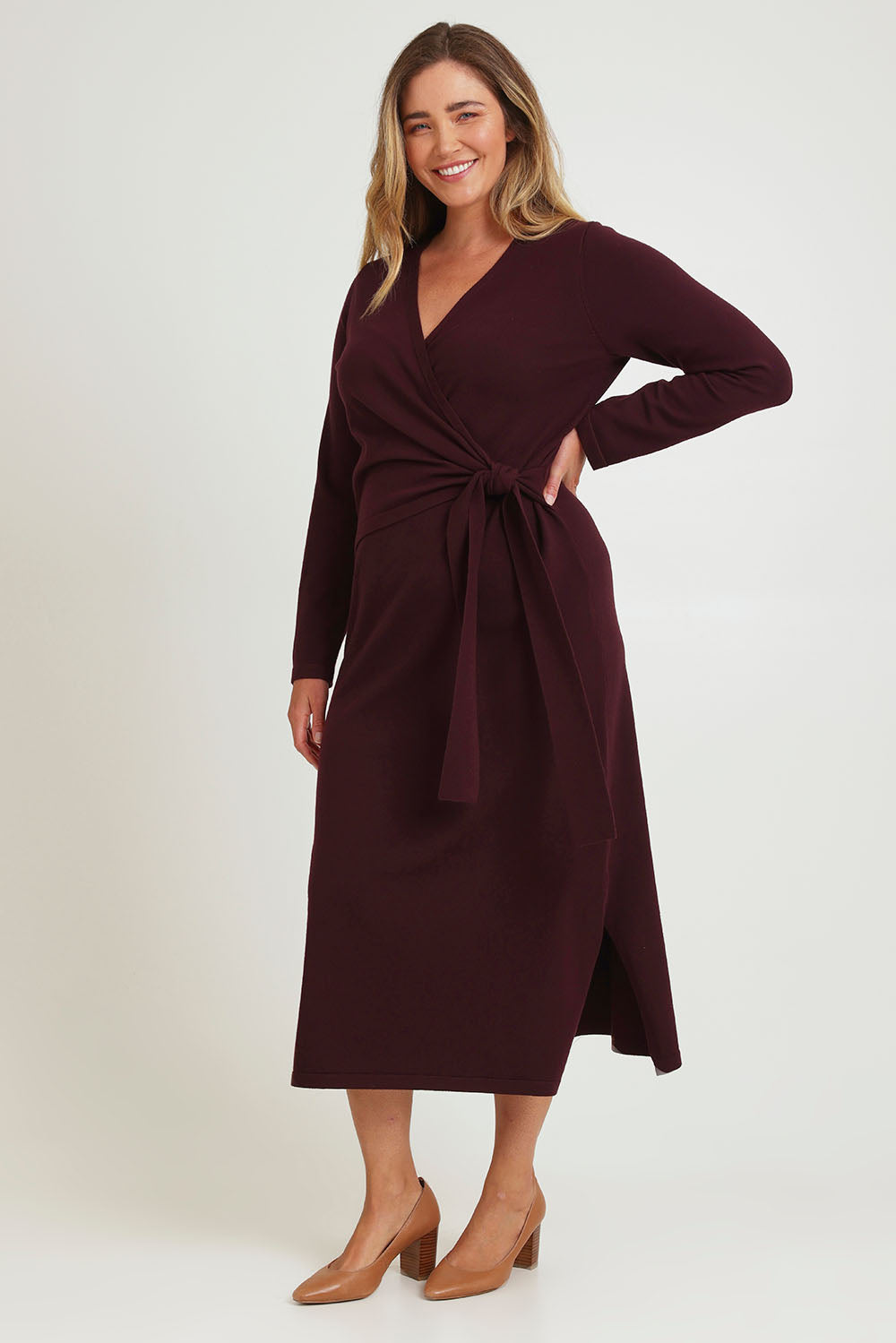 Model Chanel wearing size XL of The Tie Waist Faux Wrap Knit Dress in colour Burntplum (Purple), from the front, showing the whole outfit