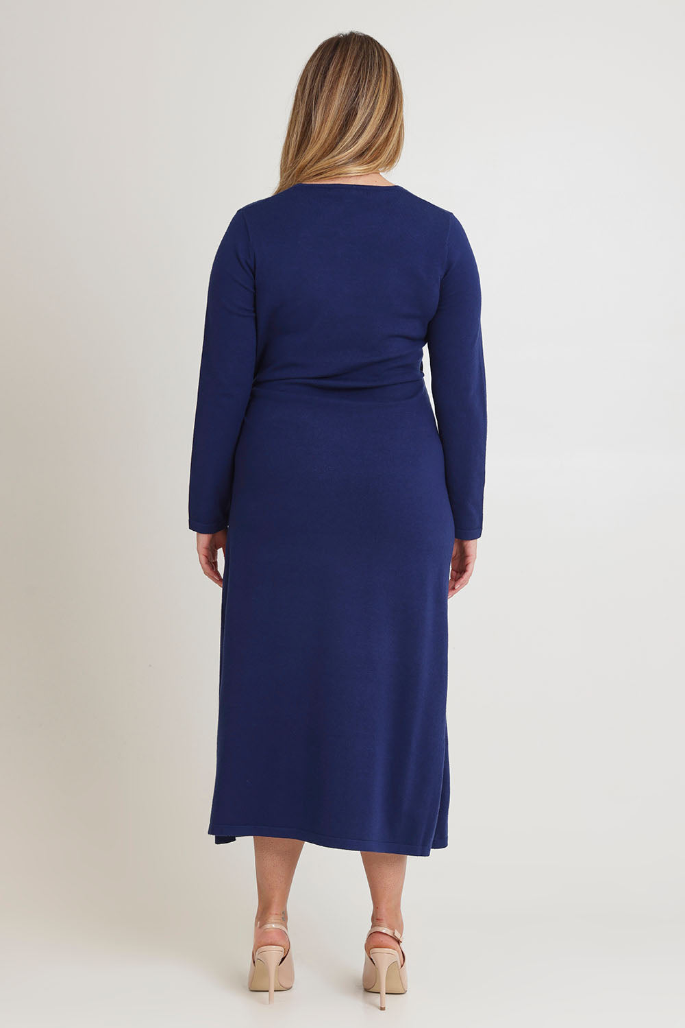 Model Chanel wearing size XL of The Tie Waist Faux Wrap Knit Dress in colour Navyblue (Blue), from the back