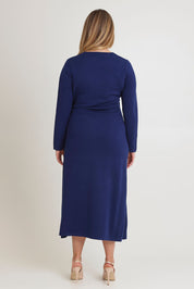 Model Chanel wearing size XL of The Tie Waist Faux Wrap Knit Dress in colour Navyblue (Blue), from the back
