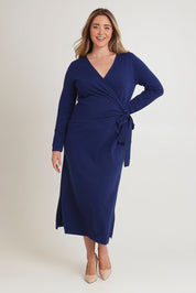 Model Chanel wearing size XL of The Tie Waist Faux Wrap Knit Dress in colour Navyblue (Blue), from the front, showing the whole outfit
