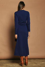 Model Madeline wearing size S of The Tie Waist Faux Wrap Knit Dress in colour Navyblue (Blue), from the back