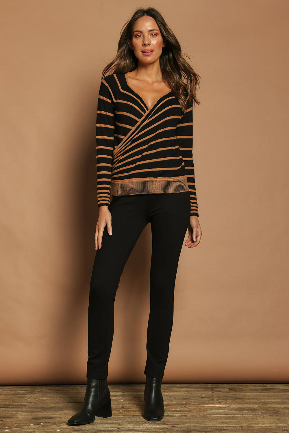 Model Madeline wearing size S of The Stripe Faux Wrap Jumper in colour Blacktan (Black), from the front, showing the whole outfit