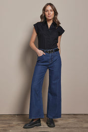 Model Madeline wearing size 10 of The Cap Sleeve Cotton Stretch Shirt in colour Black (Black), from the front, showing the whole outfit