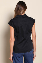 Model Madelinec wearing size 10 of the The Cap Sleeve Cotton Stretch Shirt - Black in colour Black, from the back