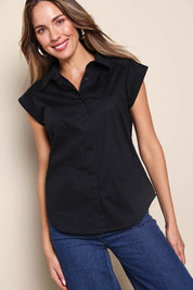 Model Madelinec wearing size 10 of the The Cap Sleeve Cotton Stretch Shirt - Black in colour Black, in a cropped view