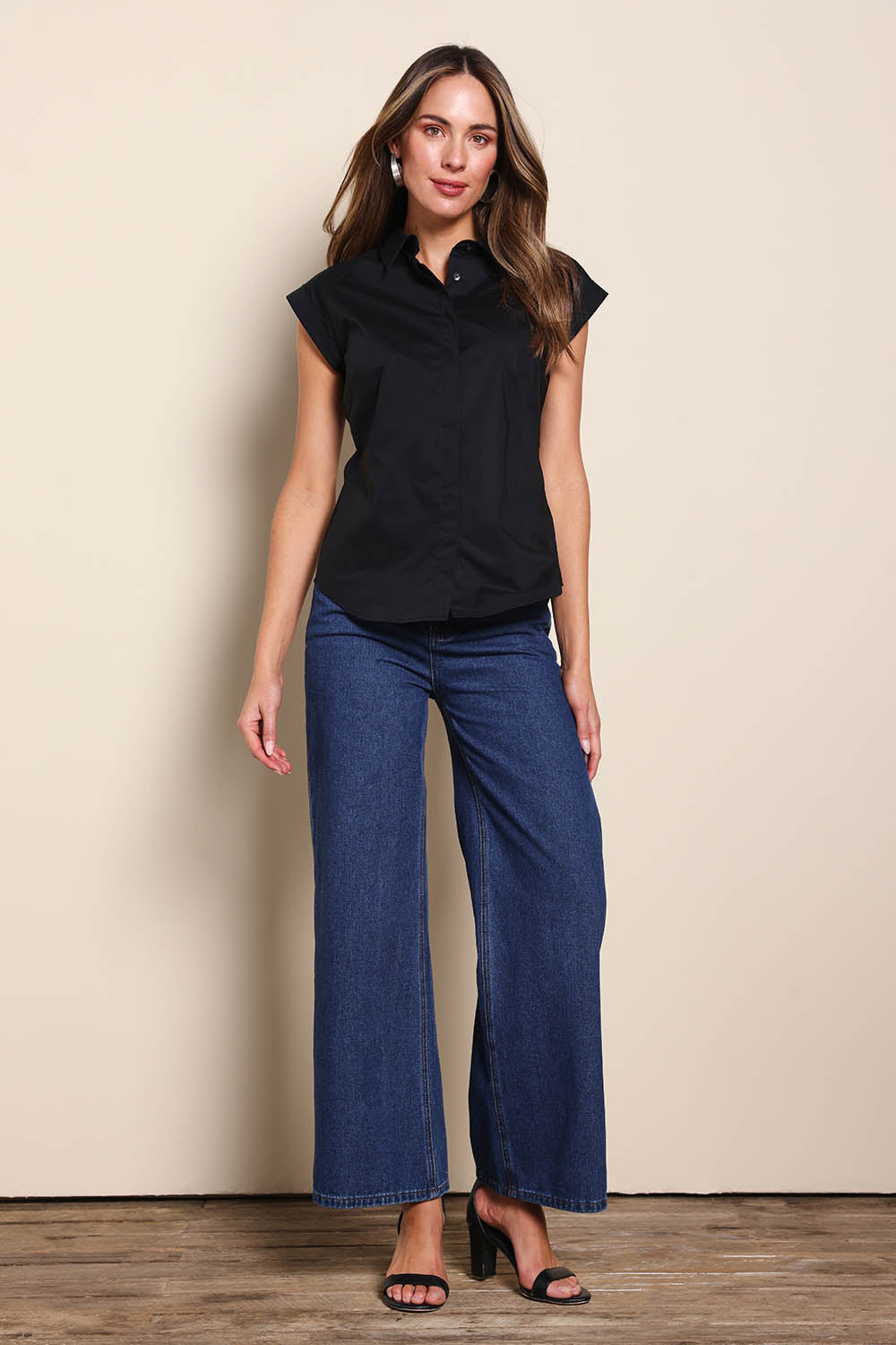 Model Madelinec wearing size 10 of the The Cap Sleeve Cotton Stretch Shirt - Black in colour Black, from the front