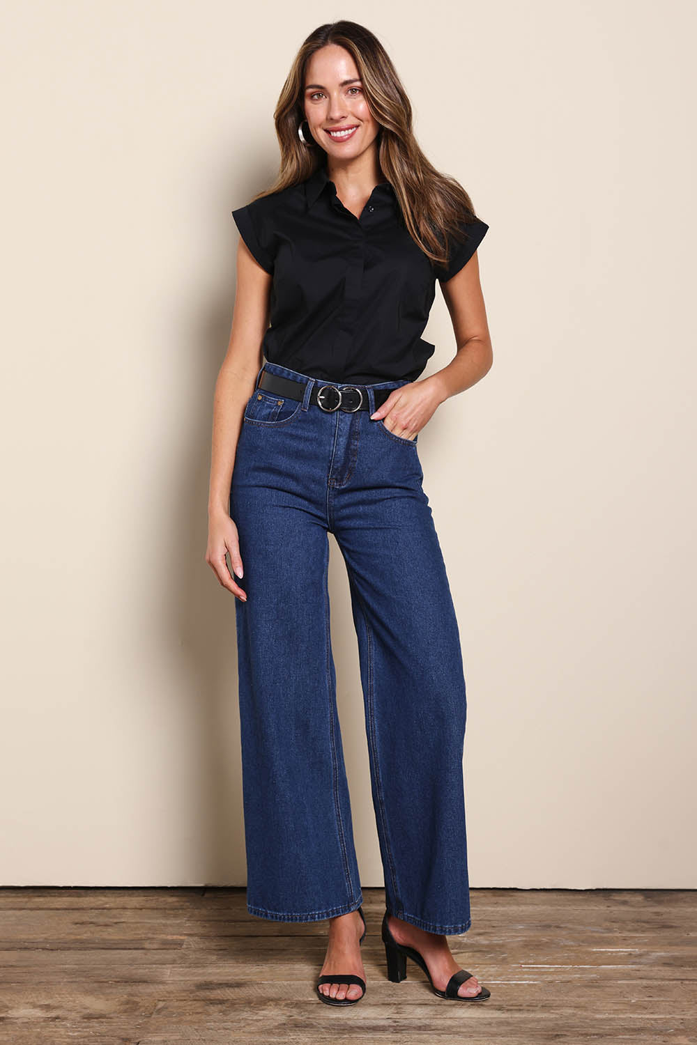 Model Madelinec wearing size 10 of the The Cap Sleeve Cotton Stretch Shirt - Black in colour Black, from the front