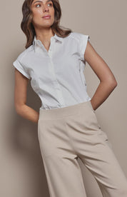 Model Madeline wearing size 10 of The Cap Sleeve Cotton Stretch Shirt in colour White (White), from the front, cropped image