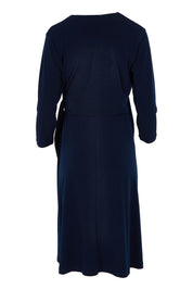 Product shot of The Tie Waist Dress in colour Navy (Blue), from the back