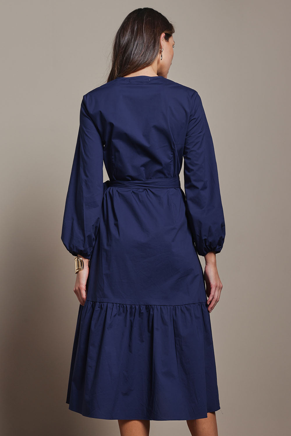 Model Madeline wearing size 10 of The Cotton Wrap Dress With Frill Detail in colour Navyblue (Blue), from the back