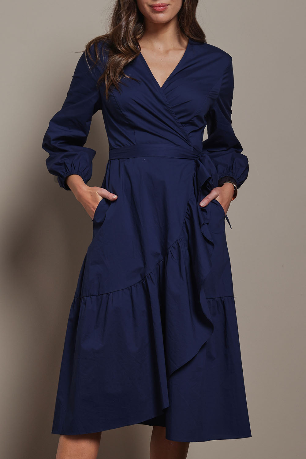 Model Madeline wearing size 10 of The Cotton Wrap Dress With Frill Detail in colour Navyblue (Blue), from the front, cropped image