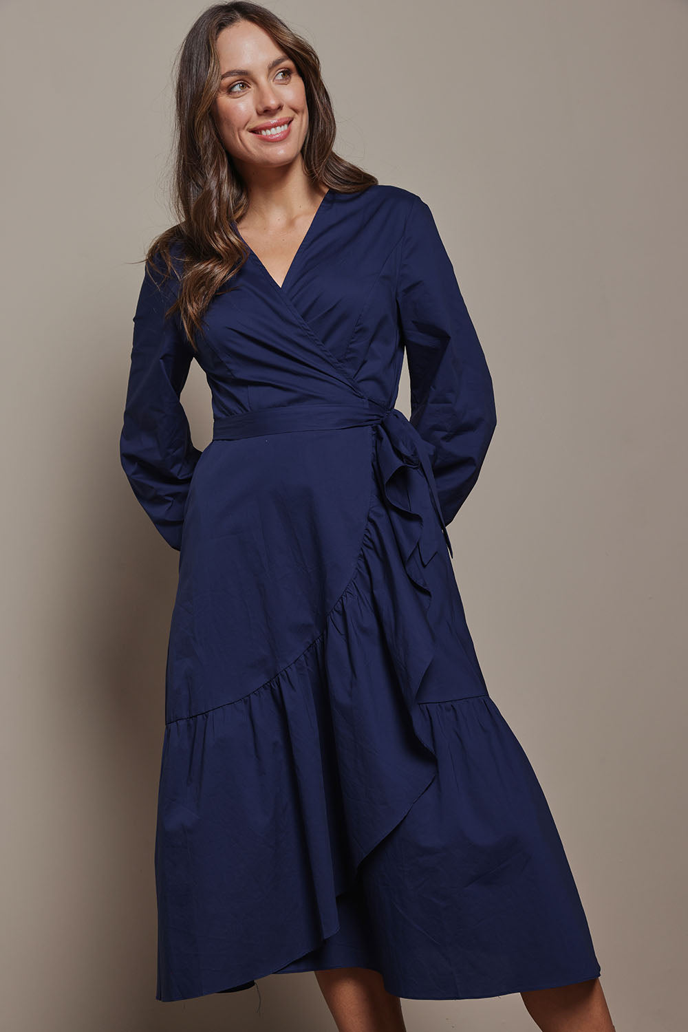 Model Madeline wearing size 10 of The Cotton Wrap Dress With Frill Detail in colour Navyblue (Blue), from the front, showing the whole outfit