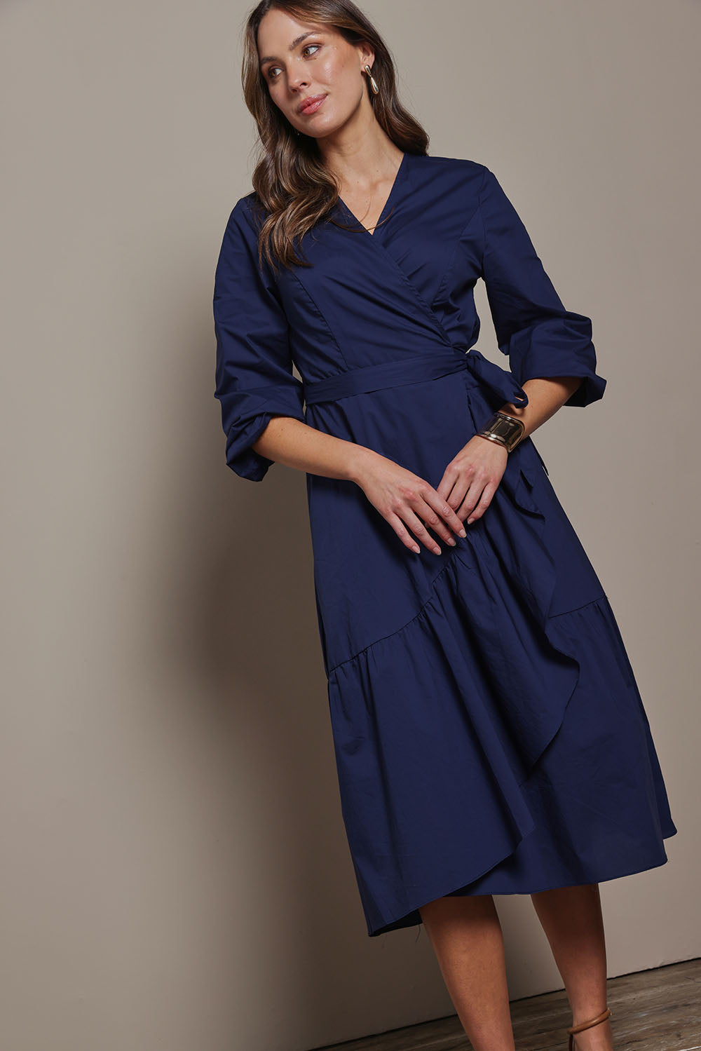 Model Madeline wearing size 10 of The Cotton Wrap Dress With Frill Detail in colour Navyblue (Blue), from the front, showing the whole outfit