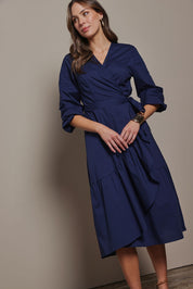 Model Madeline wearing size 10 of The Cotton Wrap Dress With Frill Detail in colour Navyblue (Blue), from the front, showing the whole outfit