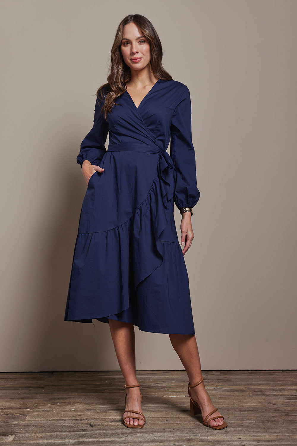 Model Madeline wearing size 10 of The Cotton Wrap Dress With Frill Detail in colour Navyblue (Blue), from the front, showing the whole outfit