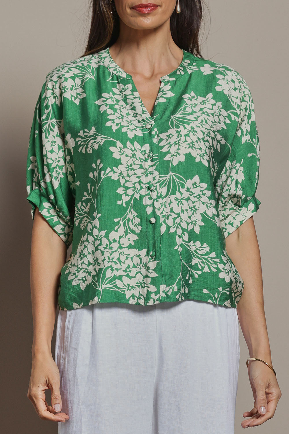 Model Amanda wearing size 10 of The Dolman Sleeve Button Up Shirt in colour Greenbloom (Green), from the front, cropped image