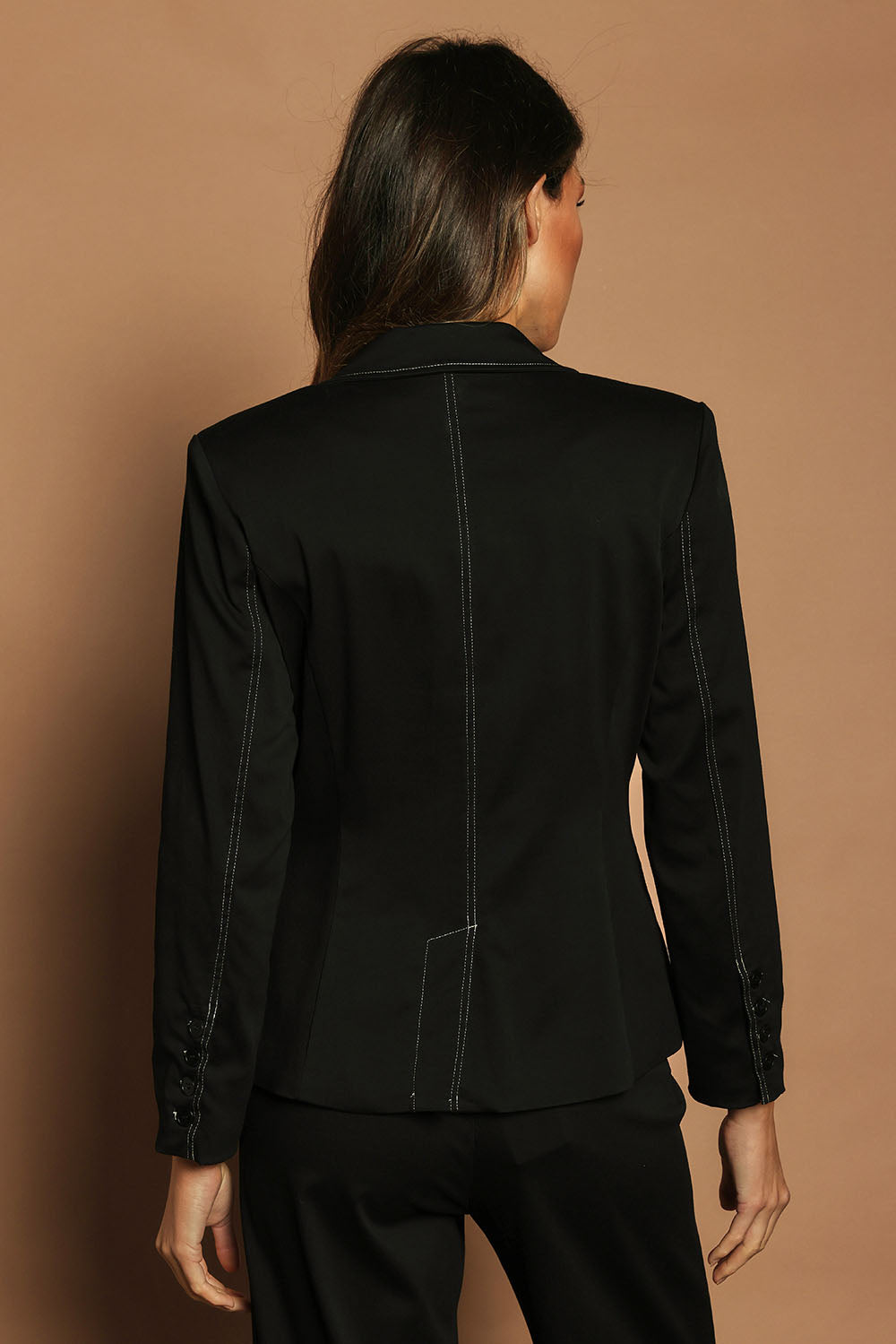 Model Madeline wearing size 10 of The Contrast Stitching Stretch Blazer in colour Black (Black), from the back