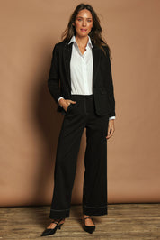 Model Madeline wearing size 10 of The Contrast Stitching Stretch Blazer in colour Black (Black), from the front, showing the whole outfit