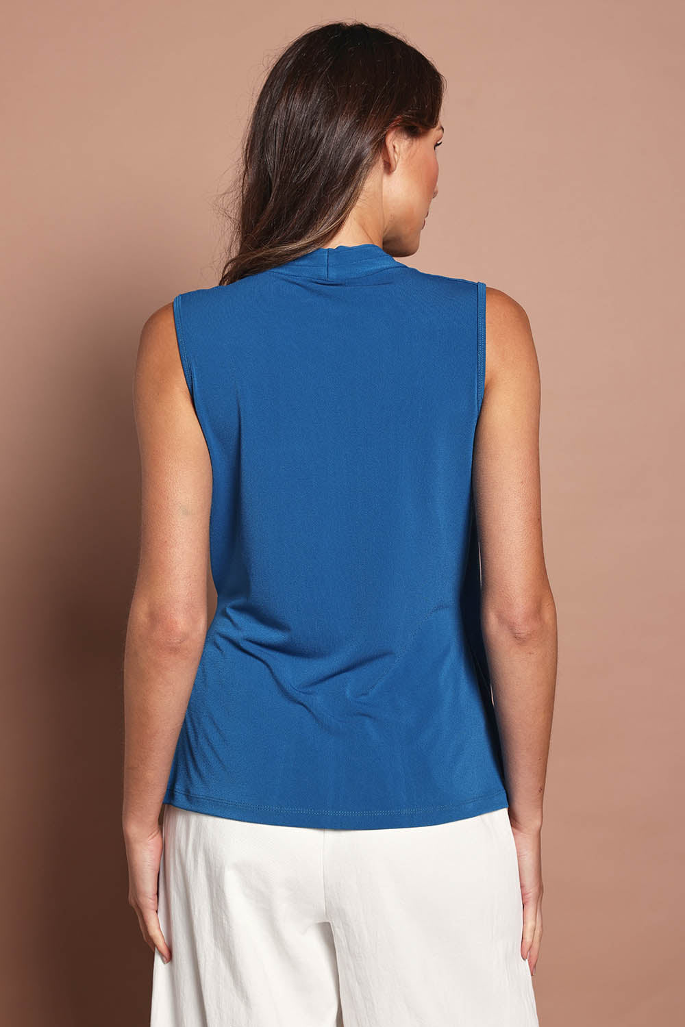 Model Madeline wearing size 10 of The Sleeveless Crossover Top in colour Tealblue (Blue), from the back