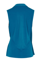 Product shot of The Sleeveless Crossover Top in colour Tealblue (Blue), from the back