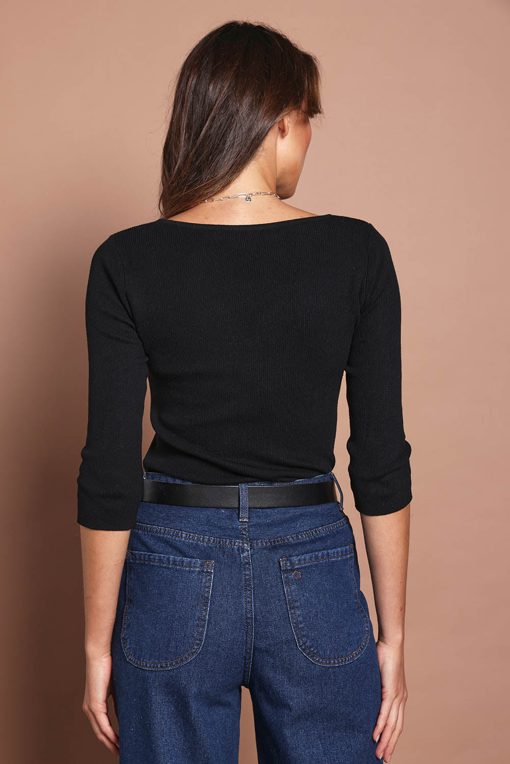 Model Madeline wearing size S of The Rib Knit Sweetheart Neck Top in colour Black (Black), from the back