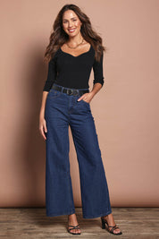 Model Madeline wearing size S of The Rib Knit Sweetheart Neck Top in colour Black (Black), from the front, showing the whole outfit