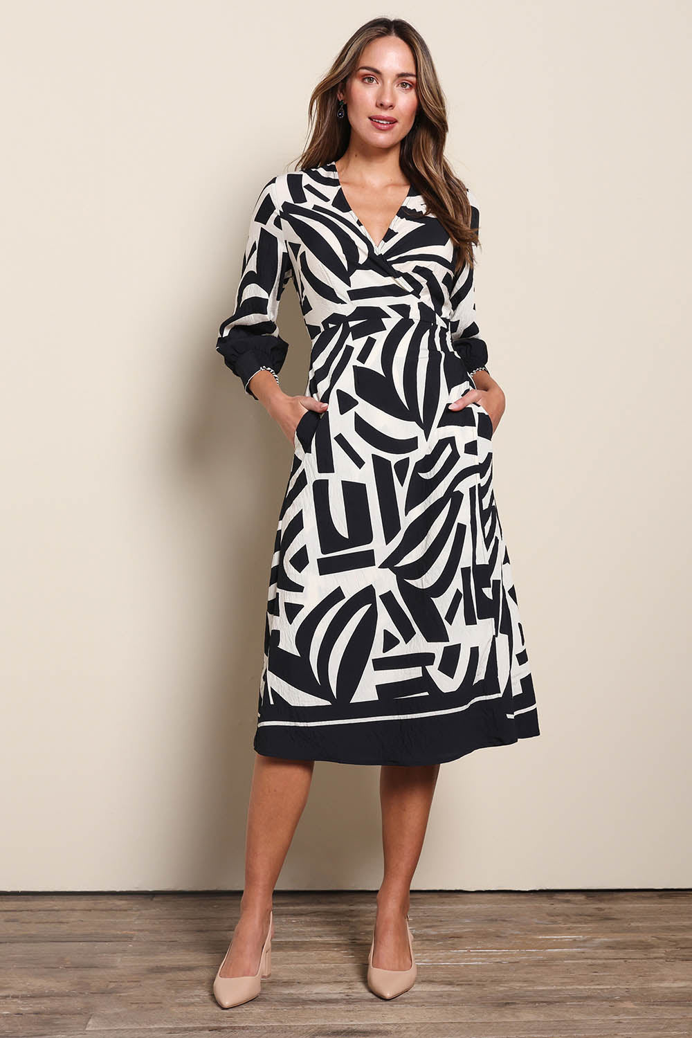 Model Madelinec wearing size 10 of the The Printed Wrap Dress - Blackabstract in colour Blackabstract, from the front