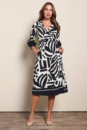 Model Madelinec wearing size 10 of the The Printed Wrap Dress - Blackabstract in colour Blackabstract, from the front
