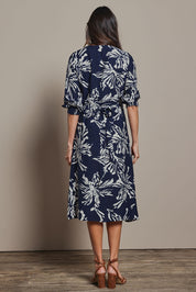 Model Amanda wearing size 10 of The Printed Wrap Dress in colour Navyfleur (Blue), from the back