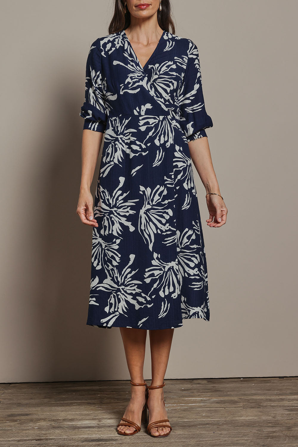 Model Amanda wearing size 10 of The Printed Wrap Dress in colour Navyfleur (Blue), from the front, cropped image