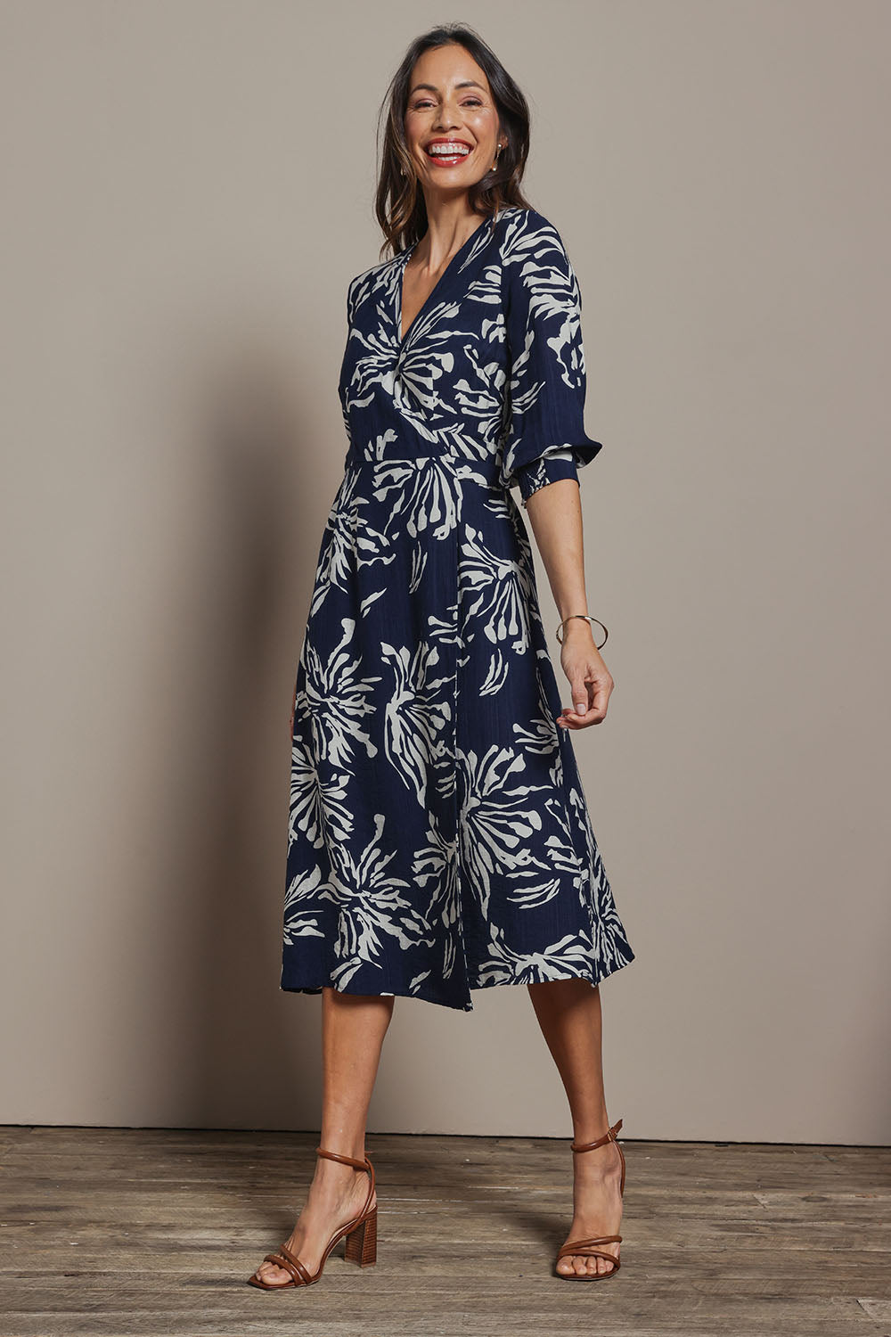 Model Amanda wearing size 10 of The Printed Wrap Dress in colour Navyfleur (Blue), from the front, showing the whole outfit