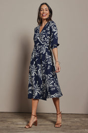 Model Amanda wearing size 10 of The Printed Wrap Dress in colour Navyfleur (Blue), from the front, showing the whole outfit