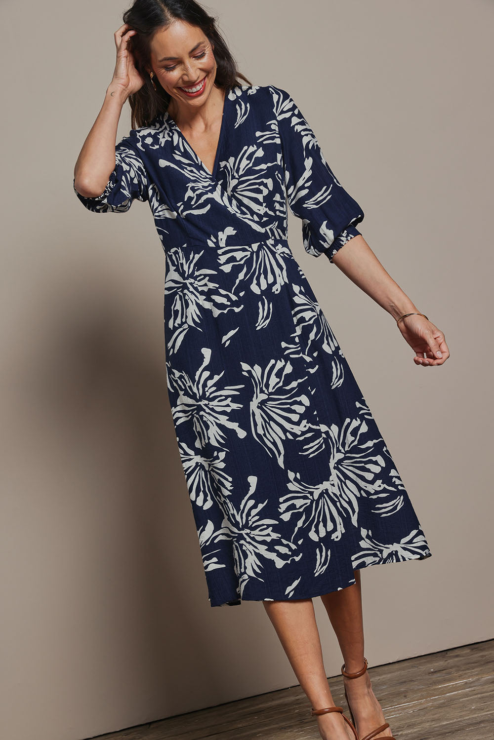 Model Amanda wearing size 10 of The Printed Wrap Dress in colour Navyfleur (Blue), from the front, showing the whole outfit