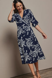 Model Amanda wearing size 10 of The Printed Wrap Dress in colour Navyfleur (Blue), from the front, showing the whole outfit