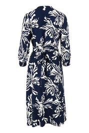 Product shot of The Printed Wrap Dress in colour Navyfleur (Blue), from the back