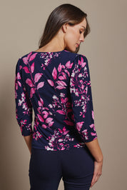 Model Madeline wearing size 10 of The Printed Square Neck Blouse in colour Nightpetal (Blue), from the back