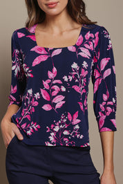 Model Madeline wearing size 10 of The Printed Square Neck Blouse in colour Nightpetal (Blue), from the front, cropped image
