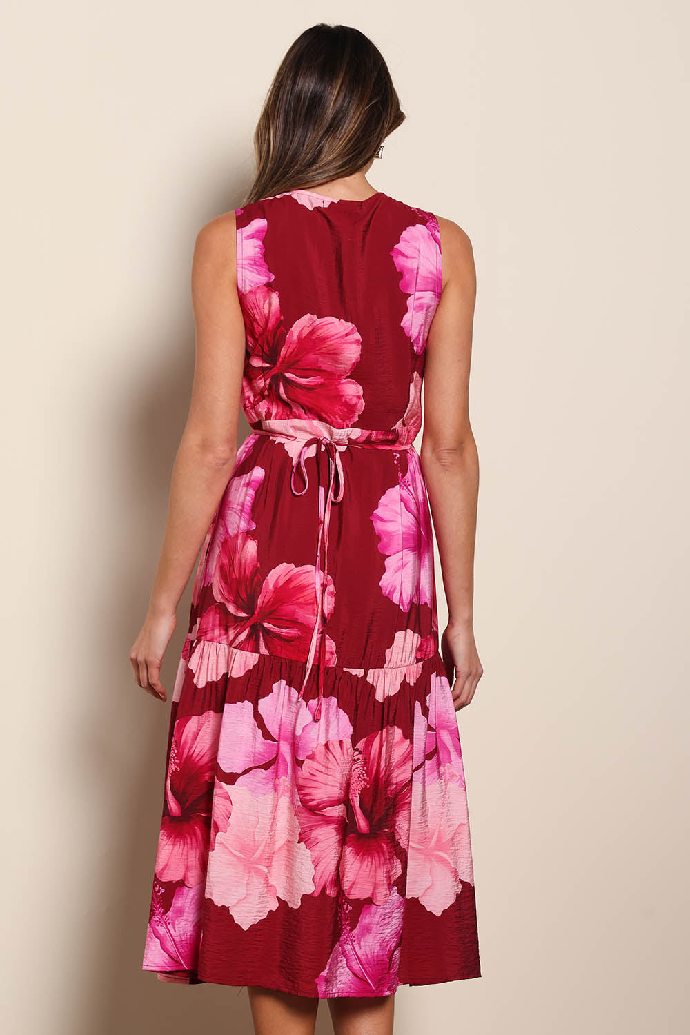 Model Madelinec wearing size 10 of the The Printed Sleeveless Wrap Dress - Pinkhibiscus in colour Pinkhibiscus, from the back