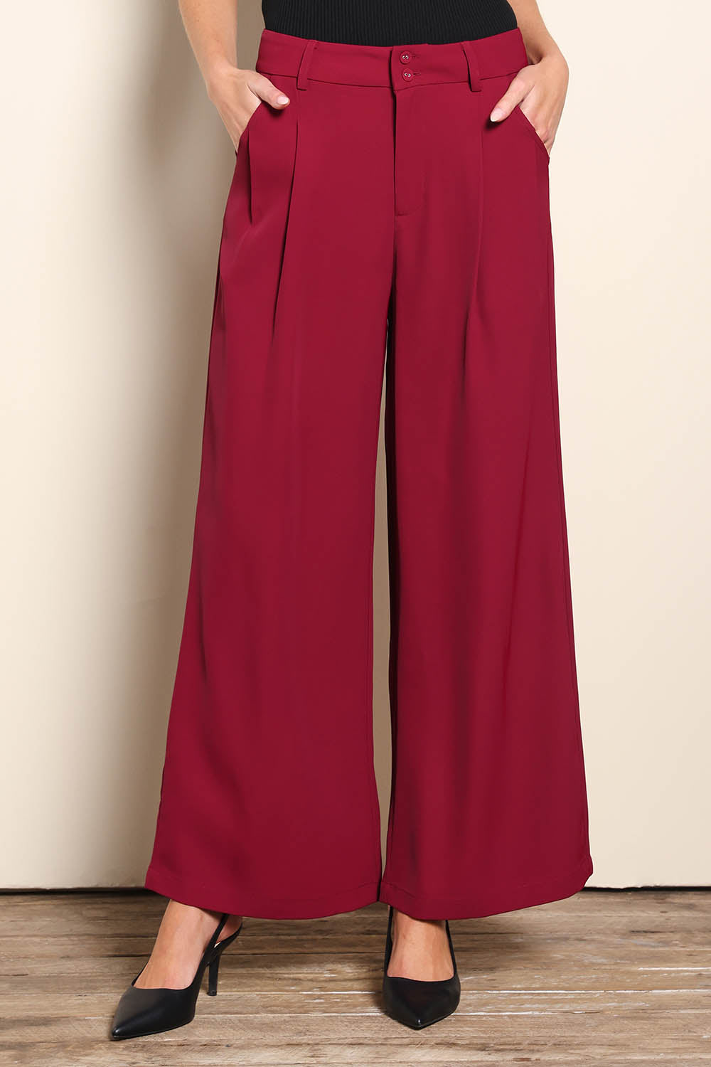 Model Madelinec wearing size 10 of the The Soft Suiting Pant – Burgundy in colour Burgundy, in a cropped view