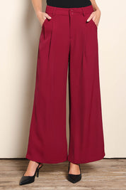Model Madelinec wearing size 10 of the The Soft Suiting Pant – Burgundy in colour Burgundy, in a cropped view