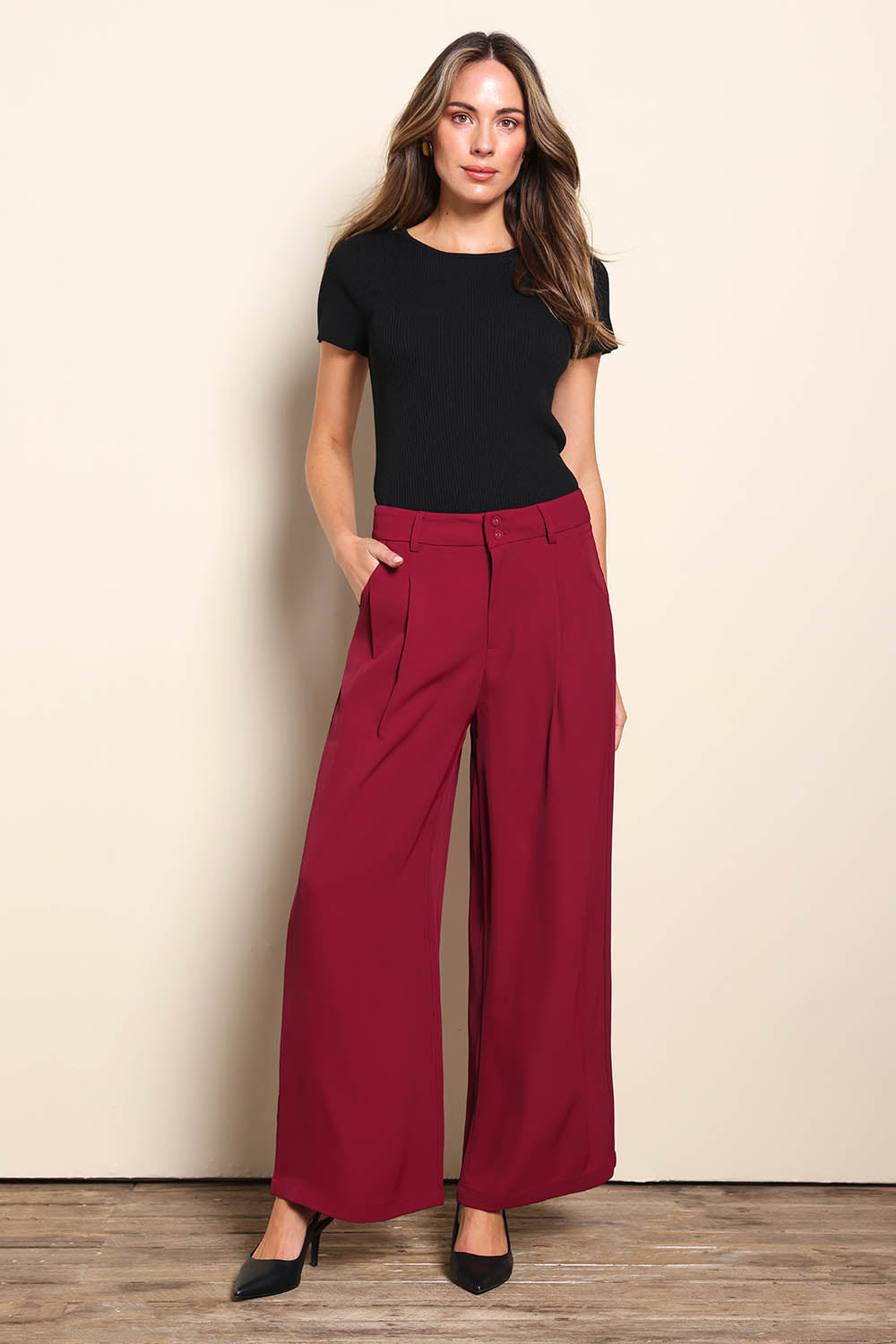 Model Madelinec wearing size 10 of the The Soft Suiting Pant – Burgundy in colour Burgundy, from the front