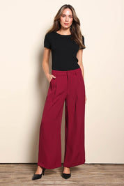 Model Madelinec wearing size 10 of the The Soft Suiting Pant – Burgundy in colour Burgundy, from the front