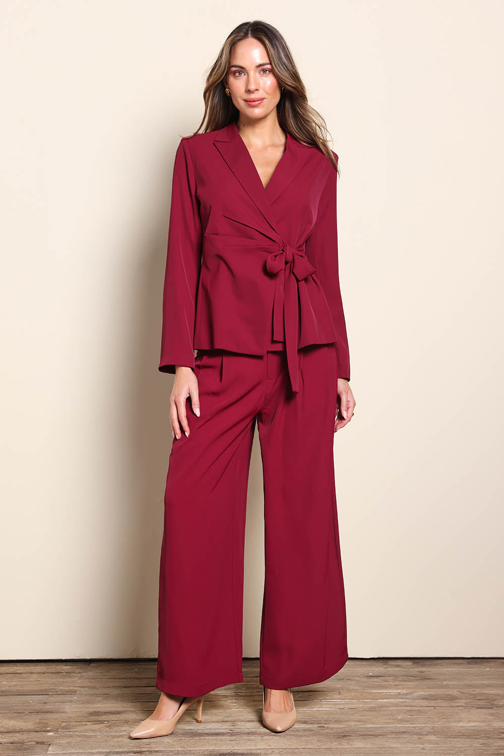 Model Madelinec wearing size 10 of the The Soft Suiting Pant – Burgundy in colour Burgundy, from the front