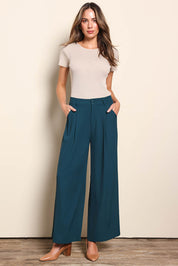 Model Madelinec wearing size 10 of the The Soft Suiting Pant – Darkteal in colour Darkteal, from the front