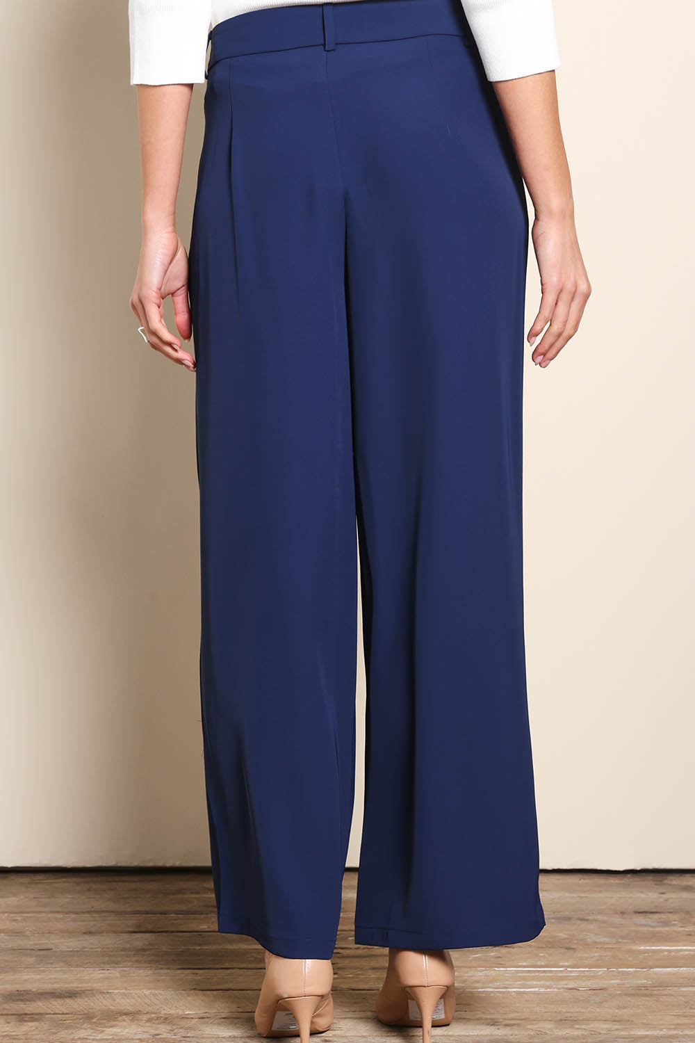 Model Madelinec wearing size 10 of the The Soft Suiting Pant – Navy in colour Navy, from the back