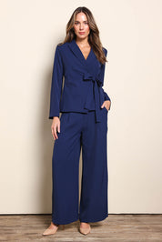 Model Madelinec wearing size 10 of the The Soft Suiting Pant – Navy in colour Navy, from the front