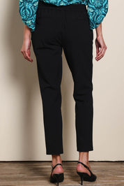 Model Madelinec wearing size 10 of the The Tapered Pull On Stretch Pant – Black in colour Black, from the back