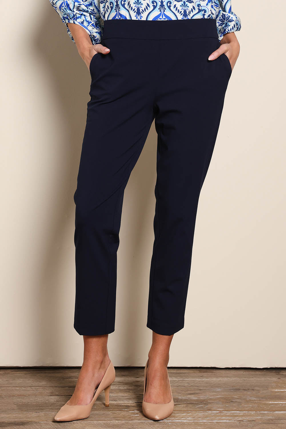 Model Madelinec wearing size 10 of the The Tapered Pull On Stretch Pant – Navy in colour Navy, in a cropped view
