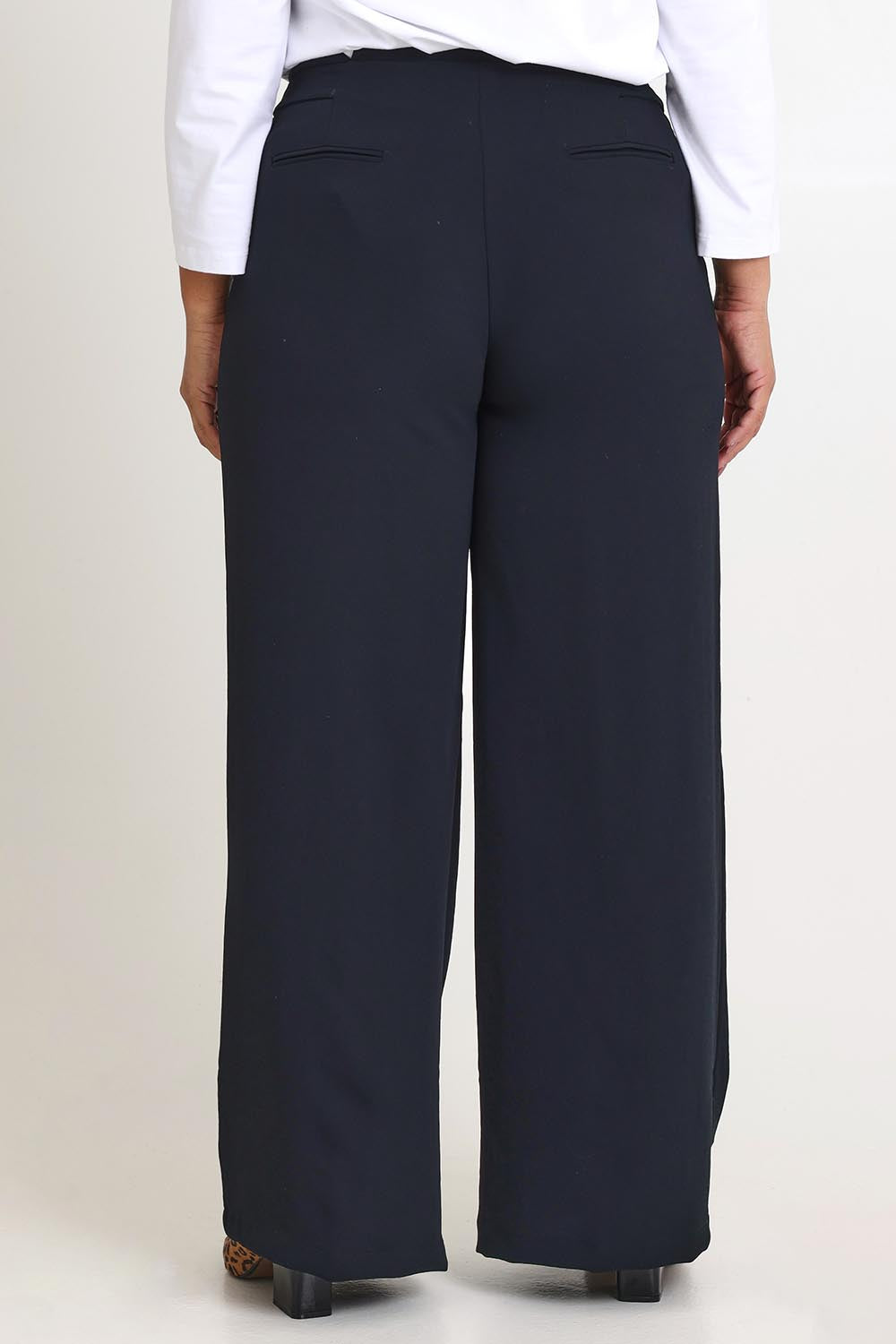 Model Ashleigh wearing size 16 of The Tab Detail Tailored Pant in colour Black (Black), from the back